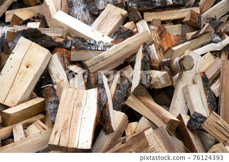 Pile of just chopped birch firewood outdoors 76124393