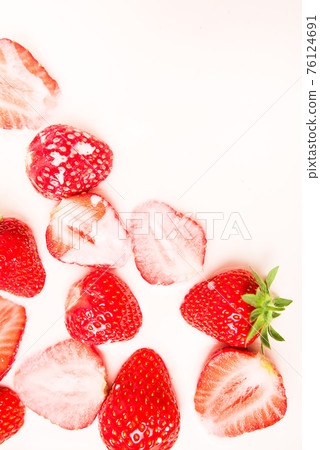 A lot of ripe juicy strawberries in milk, cream or yogurt. 76124691