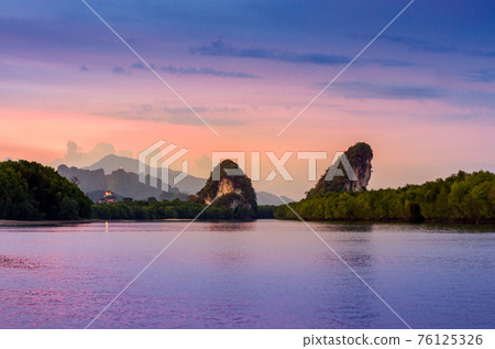 Khao kha nab nam at Krabi Thailand. The famous tourist attraction in southern of thailand. Twin mountains have rivers through the middle of the evening atmosphere with golden light. Khao kha nab nam at Krabi Thailand. The famous tourist attraction in southern of thailand. Twin mountains have rivers through the middle of the evening atmosphere with golden light. 76125326
