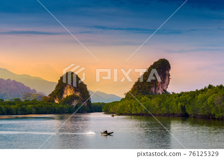 Khao kha nab nam at Krabi Thailand. The famous tourist attraction in southern of thailand. Twin mountains have rivers through the middle of the evening atmosphere with golden light. Khao kha nab nam at Krabi Thailand. The famous tourist attraction in southern of thailand. Twin mountains have rivers through the middle of the evening atmosphere with golden light. 76125329