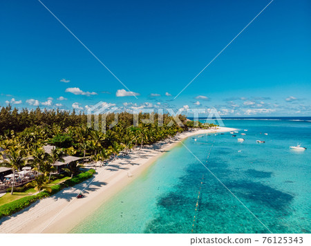 Luxury beach with resort and blue ocean in Mauritius. Aerial view 76125343