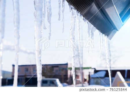 ice and icicles after freezing rain. Ice covered car window close up. winter weather ice and icicles after freezing rain. Ice covered car window close up. winter weather 76125844