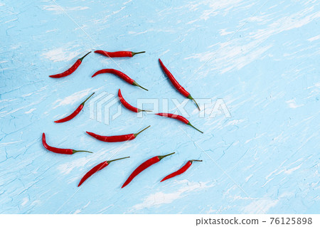 chili pepper on a blue background. Spicy food, Mexican cuisine. copy space chili pepper on a blue background. Spicy food, Mexican cuisine. copy space 76125898