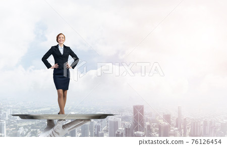 Confident elegant businesswoman presented on metal tray against cityscape background Confident elegant businesswoman presented on metal tray against cityscape background 76126454