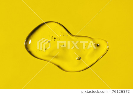 Clear liquid gel smear isolated on yellow background. Top view. Body and face care spa cosmetic concept. Transparent serum or hyaluronic acid texture Clear liquid gel smear isolated on yellow background. Top view. Body and face care spa cosmetic concept. Transparent serum or hyaluronic acid texture 76126572