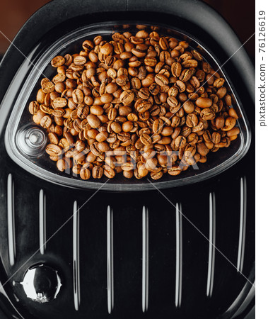 coffee beans in coffeemaker bean container, top view 76126619