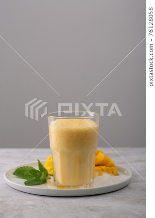 Lassi is a popular traditional yogurt based cold drink with mango in India Lassi is a popular traditional yogurt based cold drink with mango in India 76128058