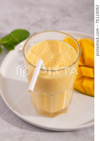 Lassi is a popular traditional yogurt based cold drink with mango in India Lassi is a popular traditional yogurt based cold drink with mango in India 76128062
