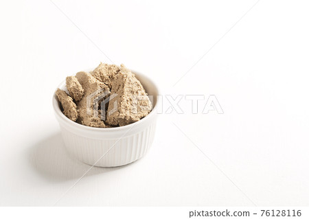Vegetable-based halva sweet prepared from seeds on white Vegetable-based halva sweet prepared from seeds on white 76128116