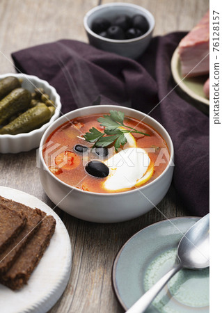 Solyanka, Russian soup with sausage, olives and capers Solyanka, Russian soup with sausage, olives and capers 76128157
