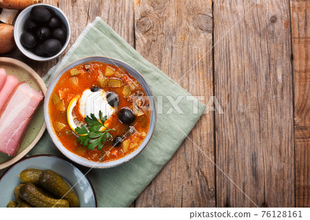Solyanka, Russian soup with sausage, olives and capers Solyanka, Russian soup with sausage, olives and capers 76128161