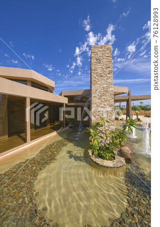 Modern House With Pebble Pond In Foreground 76128993
