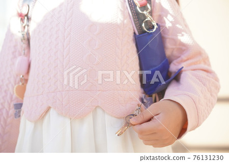A navy blue key case attached to a school bag belonging to a first grade elementary school girl 76131230