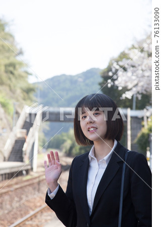 Business person waving at the platform of the station Business person waving at the platform of the station 76133090