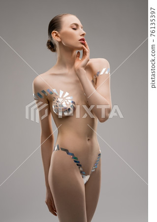 Female model sexy portrait in underwear from metallic tape Female model sexy portrait in underwear from metallic tape 76135397