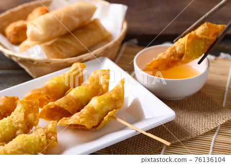 Asian deep fried crispy wonton stuffed with minced pork, quail egg and shrimp Asian deep fried crispy wonton stuffed with minced pork, quail egg and shrimp 76136104