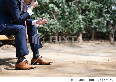 Businessmen worried outdoors 76137960