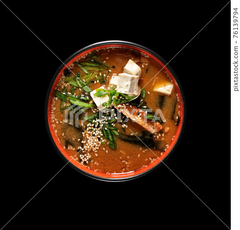 Hot miso soup with seaweed, smoked eel in bowl on black background. Japanese food. Hot miso soup with seaweed, smoked eel in bowl on black background. Japanese food. 76139794