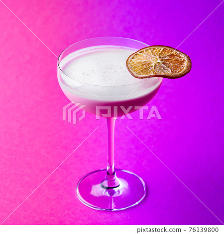 Closeup glass of milk liquor based cocktail on a purple background 76139800