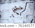 This is a photo taken on a snowy day while playing at the playground in front of the house. 76140577
