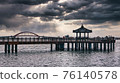 This photo was taken on a cloudy day with rain falling in the background at the pavilion in the marine park in Sokcho, Gangwon-do. 76140578