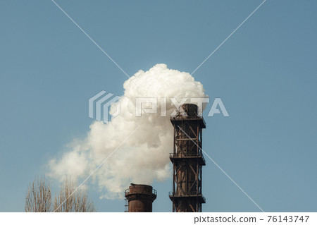 Two industrial pipes with thick smoke coming out of them. Two industrial pipes with thick smoke coming out of them. 76143747
