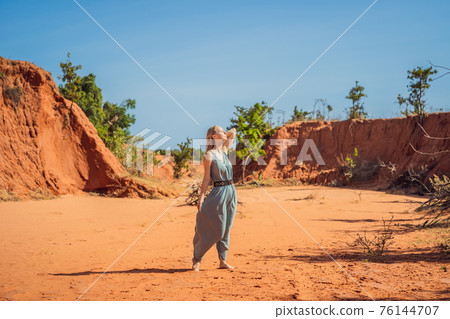 Woman tourist in red canyon, resumption of tourism concept 76144707