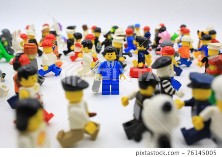 office man stand alone inside the crowd 76145005