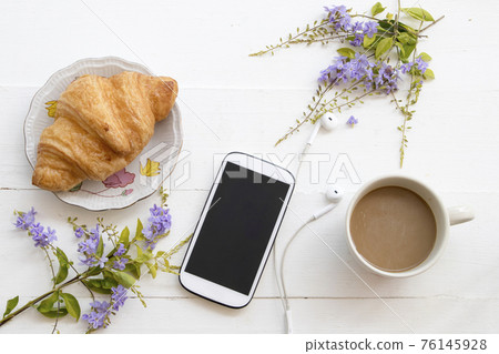 mobile phone ,hot coffee, bakery and purple flowers  76145928