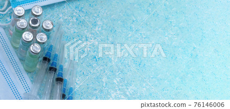 Medical instruments on blue background. Ampoule of medicine and syringe. Medical mask and vaccine. 76146006