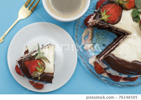 Homemade chocolate cake decorated with fresh strawberries and cup of coffee Homemade chocolate cake decorated with fresh strawberries and cup of coffee 76146505