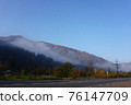Beautiful landscape in the mountains, with fog in the forest. Foggy and mountain. Car traveling on a country road. village by the road 76147709