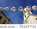 Lampshades in the air. Decorative exterior canvas lampshades. lanterns or lampions above public street above town street. Festival 76147732