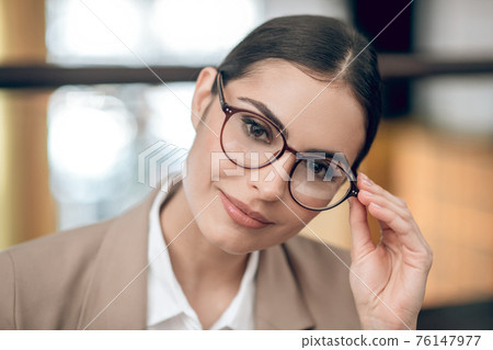 Close up of a pretty woman in eyewear Close up of a pretty woman in eyewear 76147977