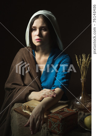 A woman in a retro dress. Historical reconstruction. A woman in a retro dress. Historical reconstruction. 76148486