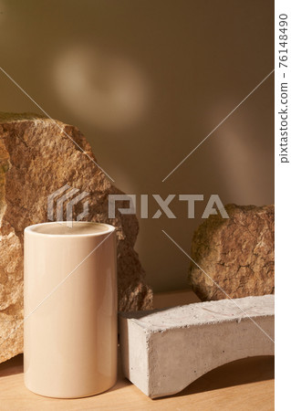 Stone and a piece of tile podium on a beige background Stone and a piece of tile podium on a beige background 76148490