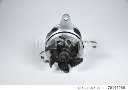 New internal combustion engine cooling water pump on a gray background. Contrast light New internal combustion engine cooling water pump on a gray background. Contrast light 76148966