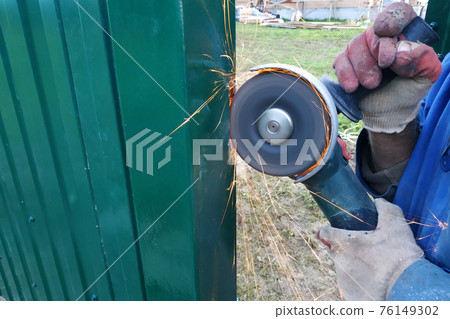 Cutting of a metal fence by means of the grinding corner car, installation of a fence and construction works. 76149302