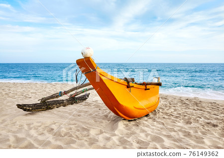 Small fishing boat on an empty beach, Sri Lanka. Small fishing boat on an empty beach, Sri Lanka. 76149362