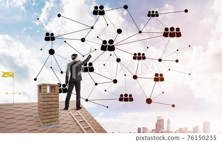 Businessman on house roof presenting networking and connection concept. Mixed media 76150235