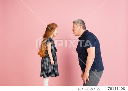 Two people, man and little girl, dad and daughter isolated over pink background. 76151408