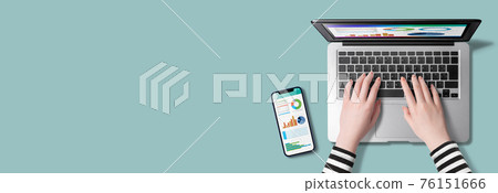 Table top with hands, smartphones and tablets typing laptops Table top with hands, smartphones and tablets typing laptops 76151666