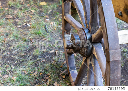 wooden large cartwheel with copy space on the background of the earth wooden large cartwheel with copy space on the background of the earth 76152395