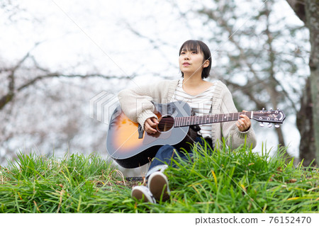 Young musician playing the guitar Young musician playing the guitar 76152470