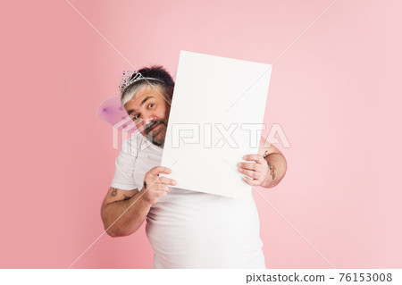 Handsome caucasian plus size male model isolated on coral pink studio background. Concept of inclusion, human emotions, facial expression Handsome caucasian plus size male model isolated on coral pink studio background. Concept of inclusion, human emotions, facial expression 76153008