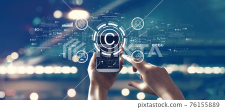 Copyright concept with person using smartphone Copyright concept with person using smartphone 76155889