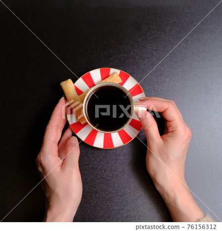 Coffee in a cup, cookies and female hands 76156312