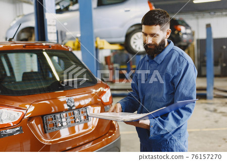 Car mechanic solves questions by phone with documents 76157270