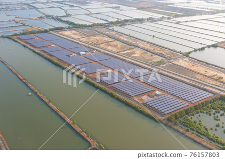 Aerial view of solar panels or solar cells on the roof in farm. Power plant with lake or river, renewable energy source in Thailand. Eco technology for electric power in industry. Photovoltaic cells Aerial view of solar panels or solar cells on the roof in farm. Power plant with lake or river, renewable energy source in Thailand. Eco technology for electric power in industry. Photovoltaic cells 76157803