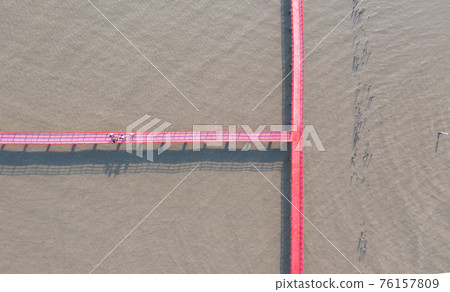 Wooden Red Bridge at Samut Sakhon, Thailand. Tourist attraction landmark with ocean sea bay. Travelling in holiday vacation. 76157809